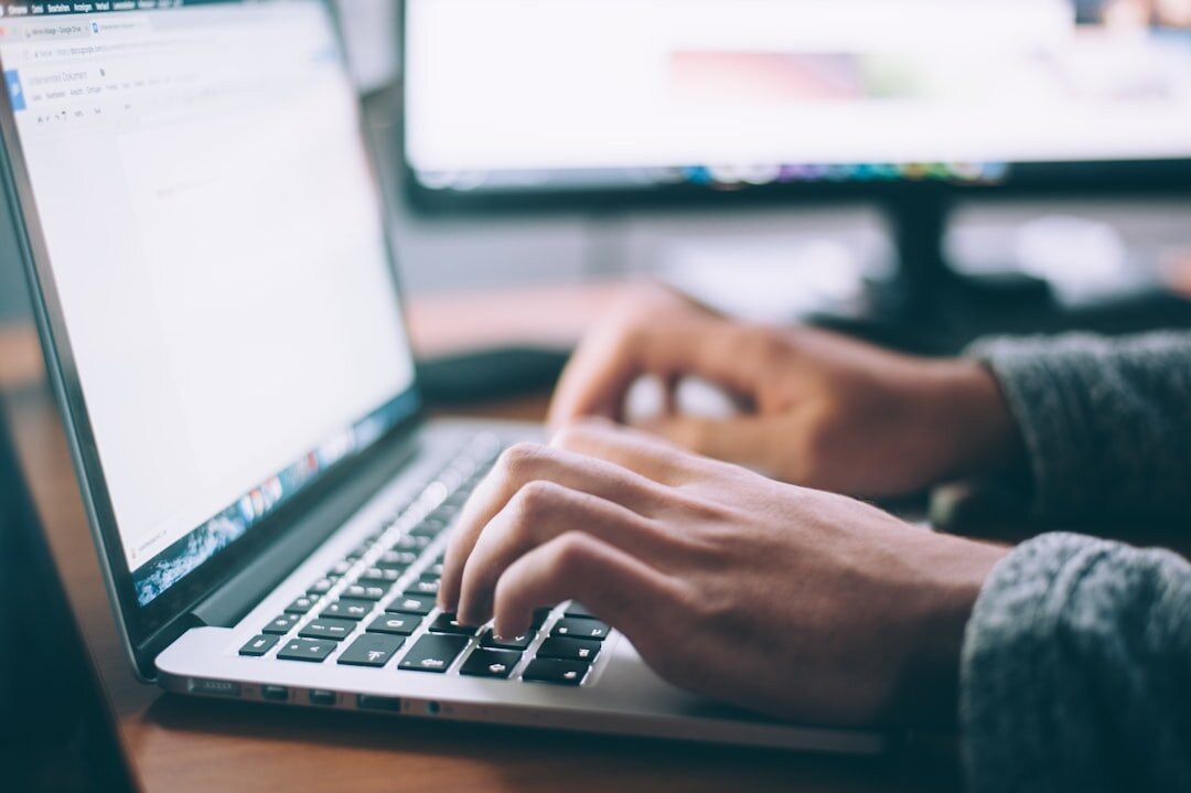 author typing on laptop